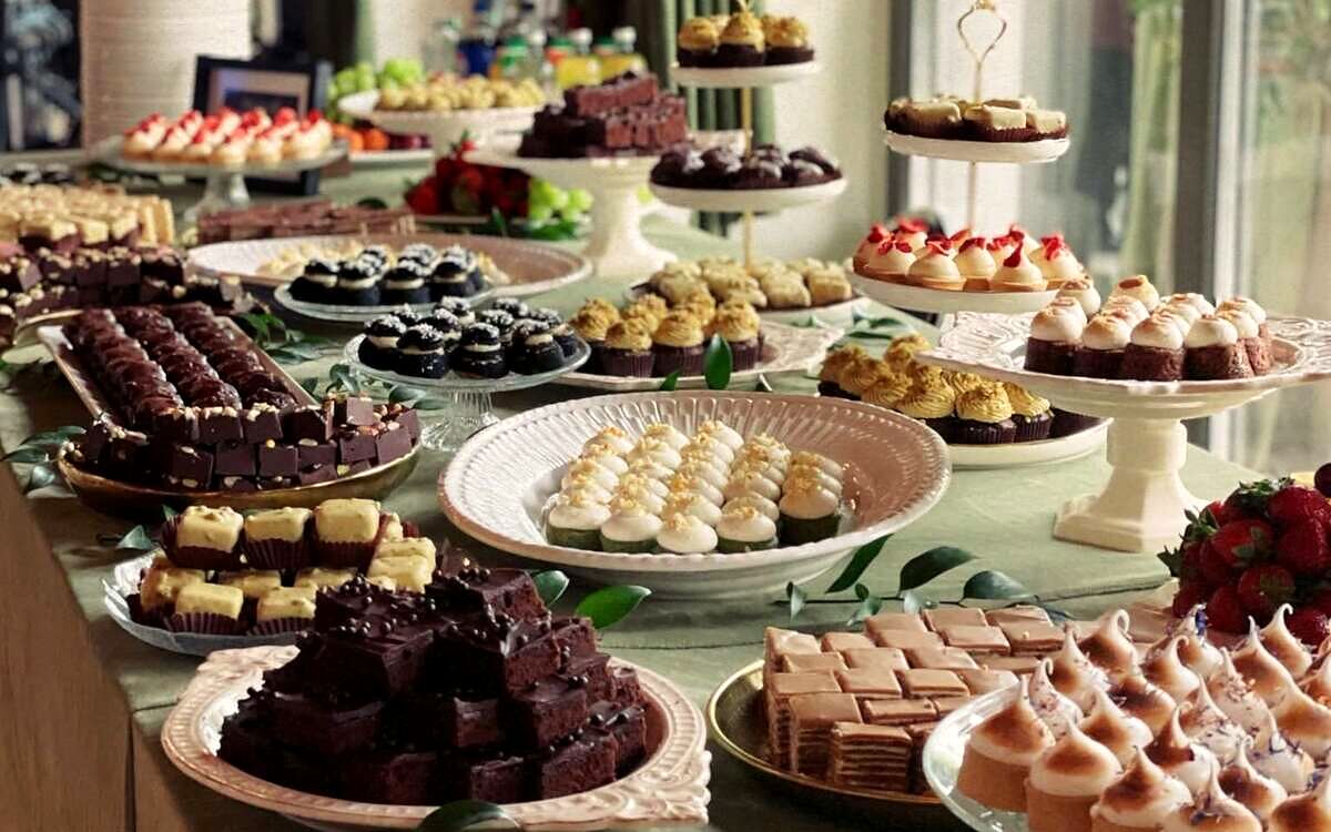 Masă dulce lungă, cu zeci de sortimente de prăjituri mici